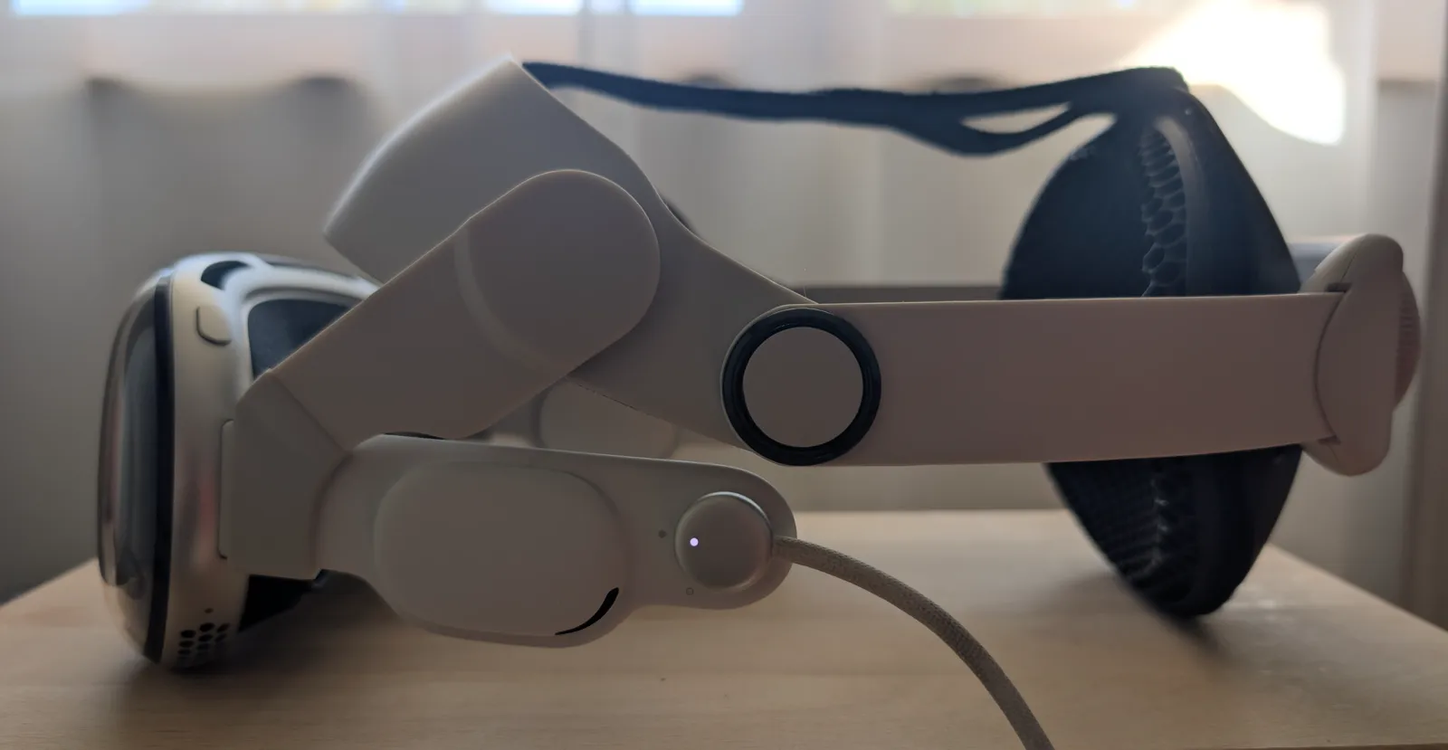 Apple Vision Pro with a third-party halo strap and the light seal removed, lying on a desk